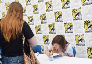 Author Tobie Easton signing "Emerge" for fans in the signing area.